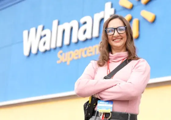 Female employee standing outside of a Walmart Supercenter