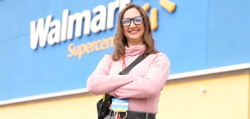 Female employee standing outside of a Walmart Supercenter