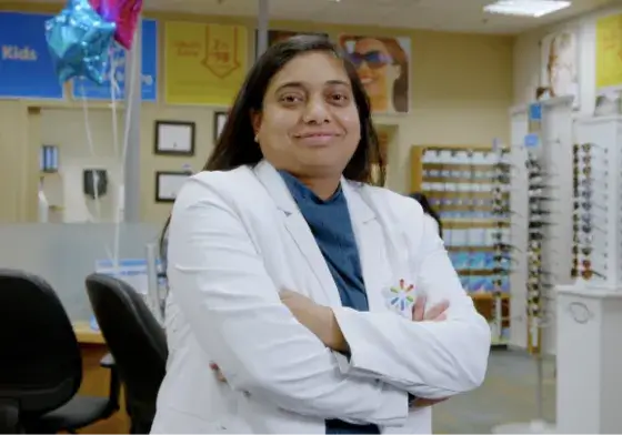 Female Walmart optometrist posing for a picture in front of the office