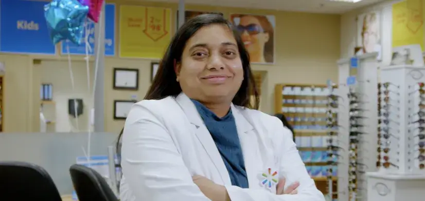 Female Walmart optometrist posing for a picture in front of the office