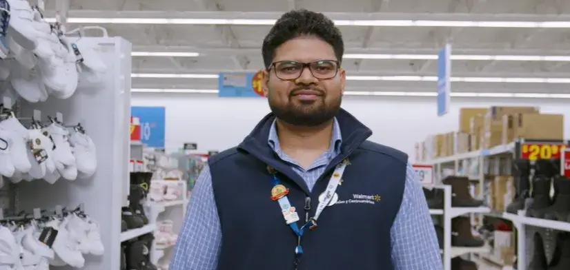 Male employee standing in a Walmart department store