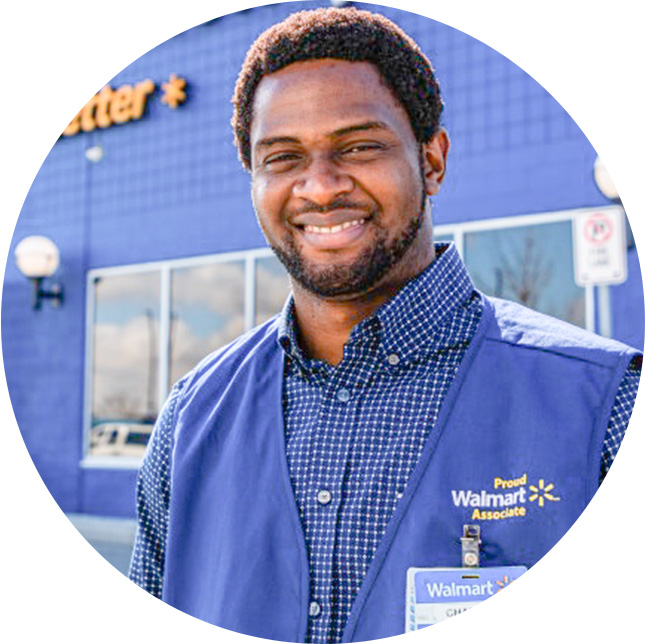 An African-American man smiling with his blue Walmart vest