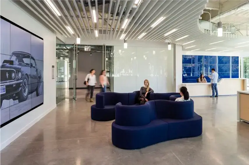An office lobby with people in various activities.