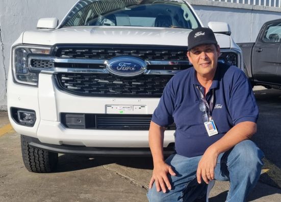 Pablo, a Paint Area Manager at Ford Argentina, in front of his Ford vehicle