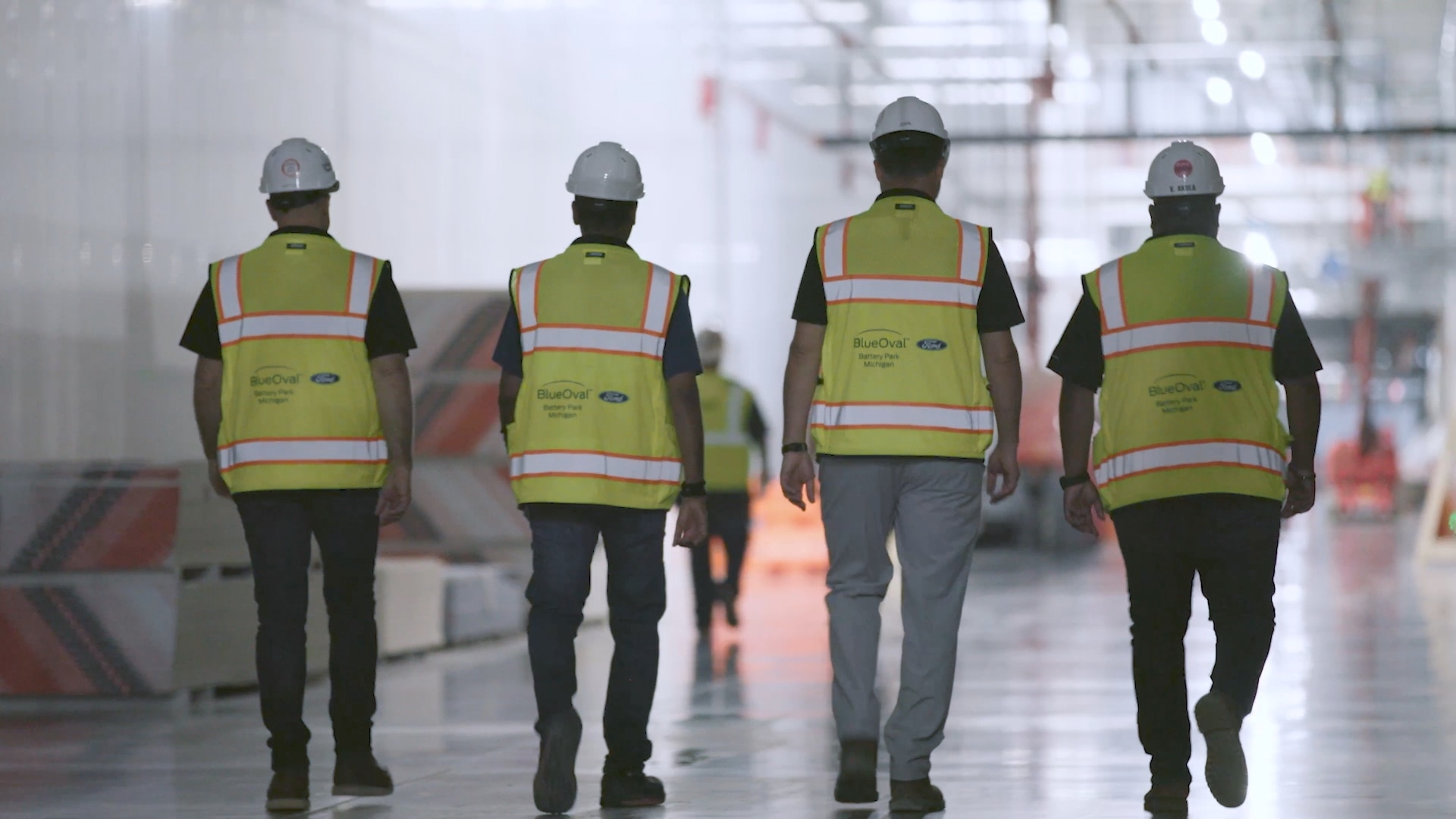 4 Ford employees walking through the plant