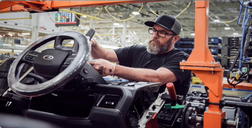 Employee assembling a steering wheel