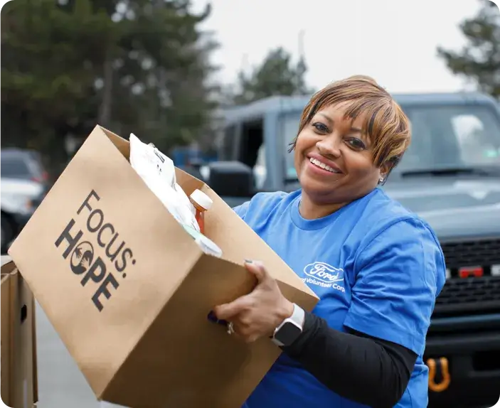 Volunteer delivering box of food