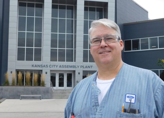Picture of Chad, an electrician, in front of Kansas City Assembly Plant