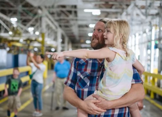 Ford employee showing his daughter where he works.