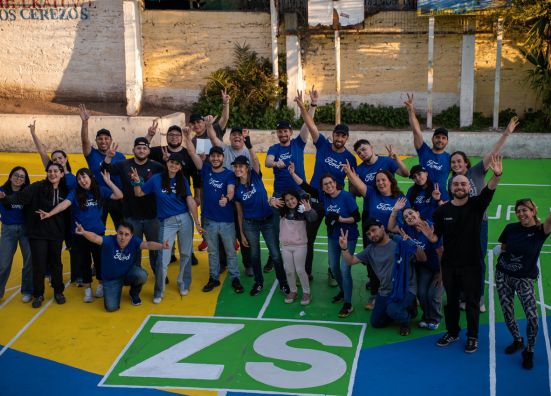 Ford employees in Chile celebrating while volunteering.