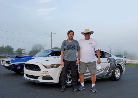 Brian, a Ford employee on the vehicle hardware engineering team, in front of Ford vehicles