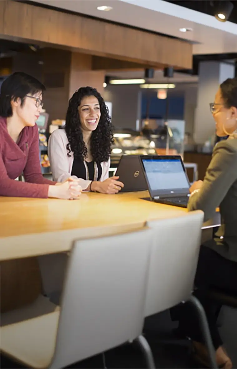 two people walking in an office space