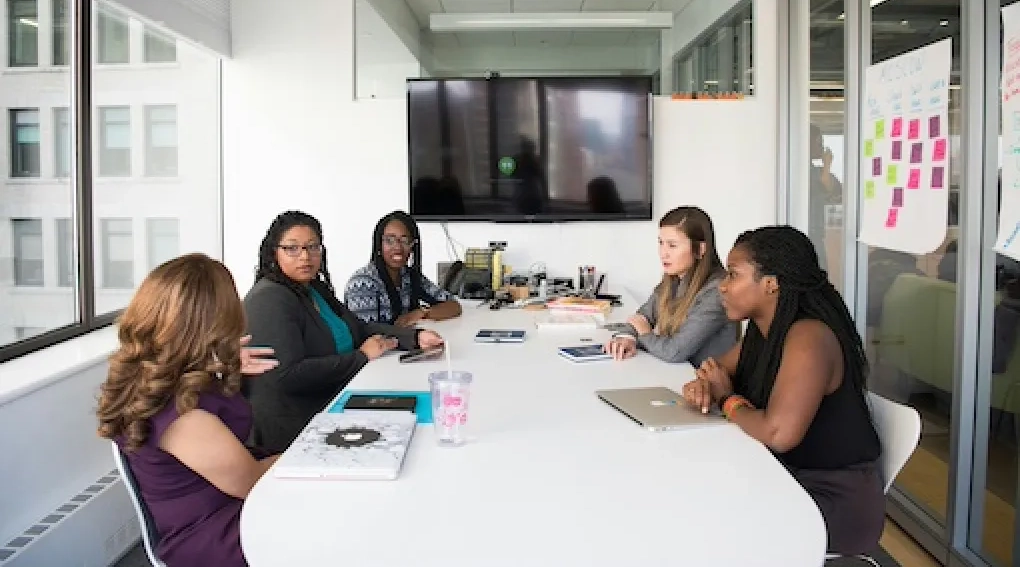 Team of women in a meeting around a conference table