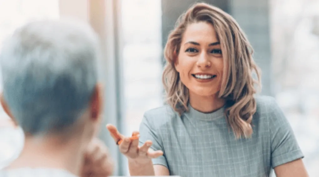 Smiling woman speaking during a business meeting