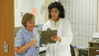 Female nurse talking with female doctor