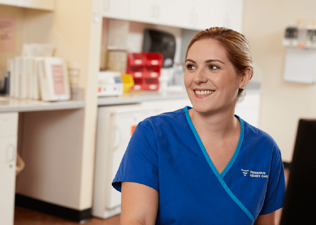 Nurse in blue scrubs smiling