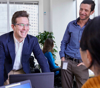 Male and Female Employees chatting and laughing together