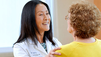 Travel nurse smiling while speaking with a patient