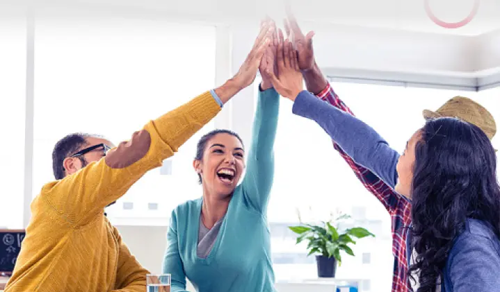 a bunch of people high fiving