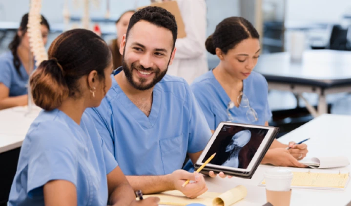 two nurses looking at a tablet