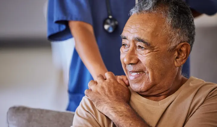 a man holding someones hand on his shoulder