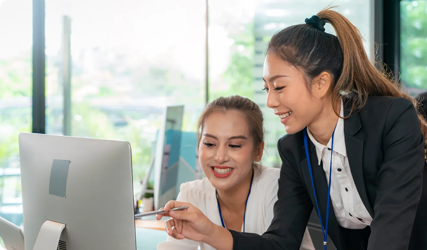 two woman looking at a computer screen
