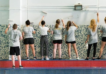 people painting a wall