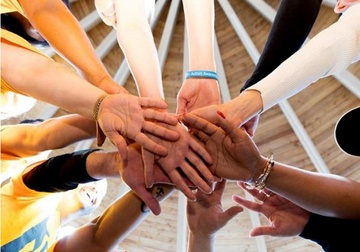 peoples hands in a circle