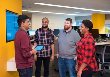 four people in an office
