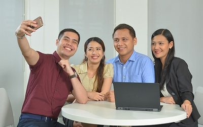 a group of people taking a selfie