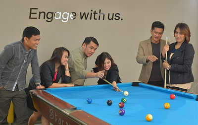 a group of people playing pool