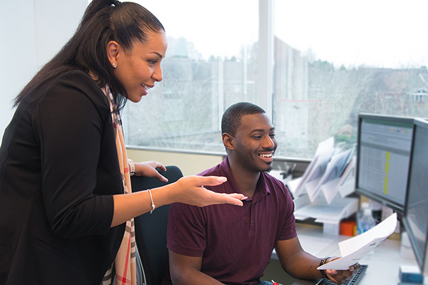 two people in front of a computer