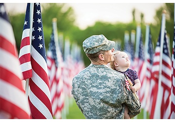 Image of Veteran holding a child