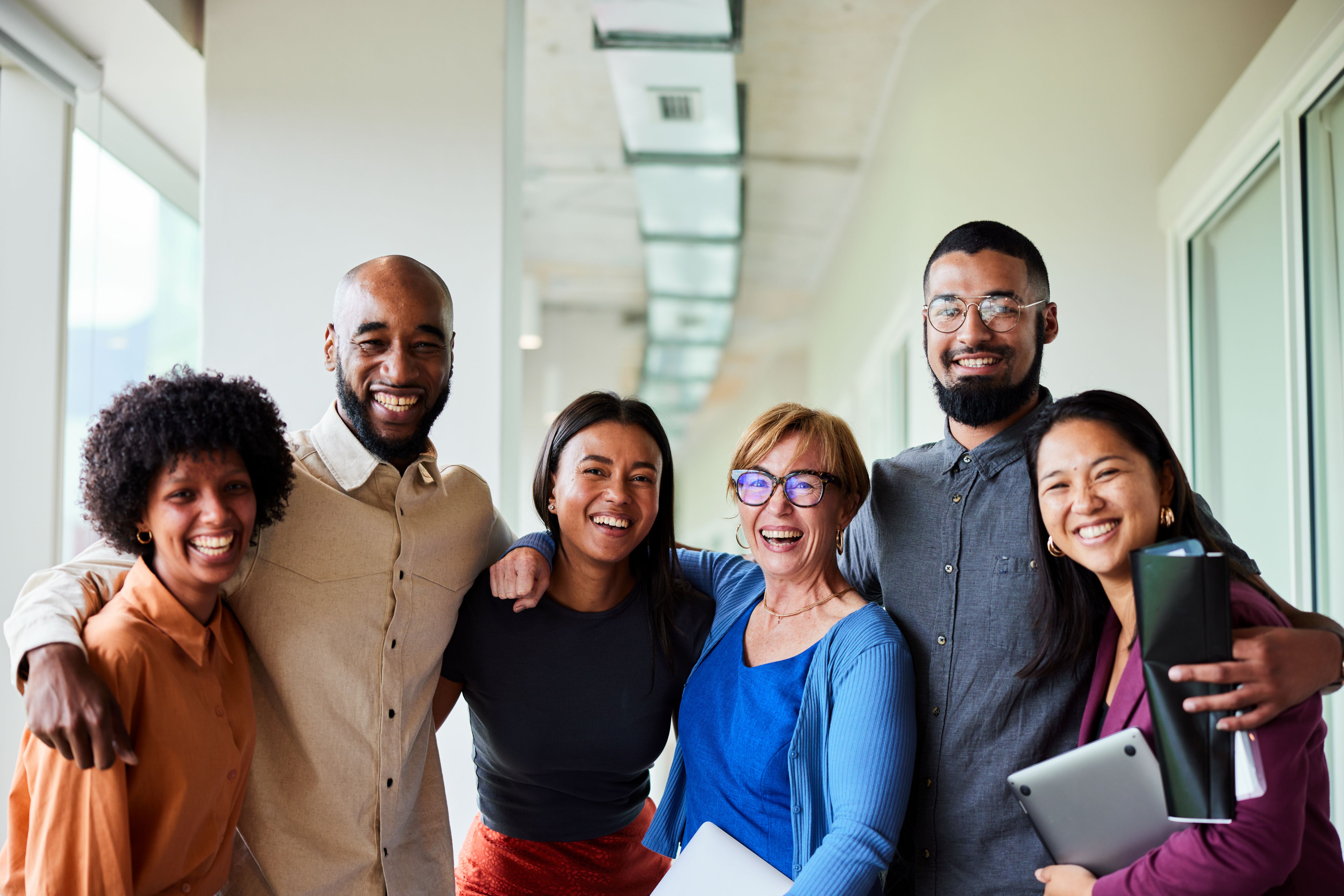 group of coworkers with arms around each other