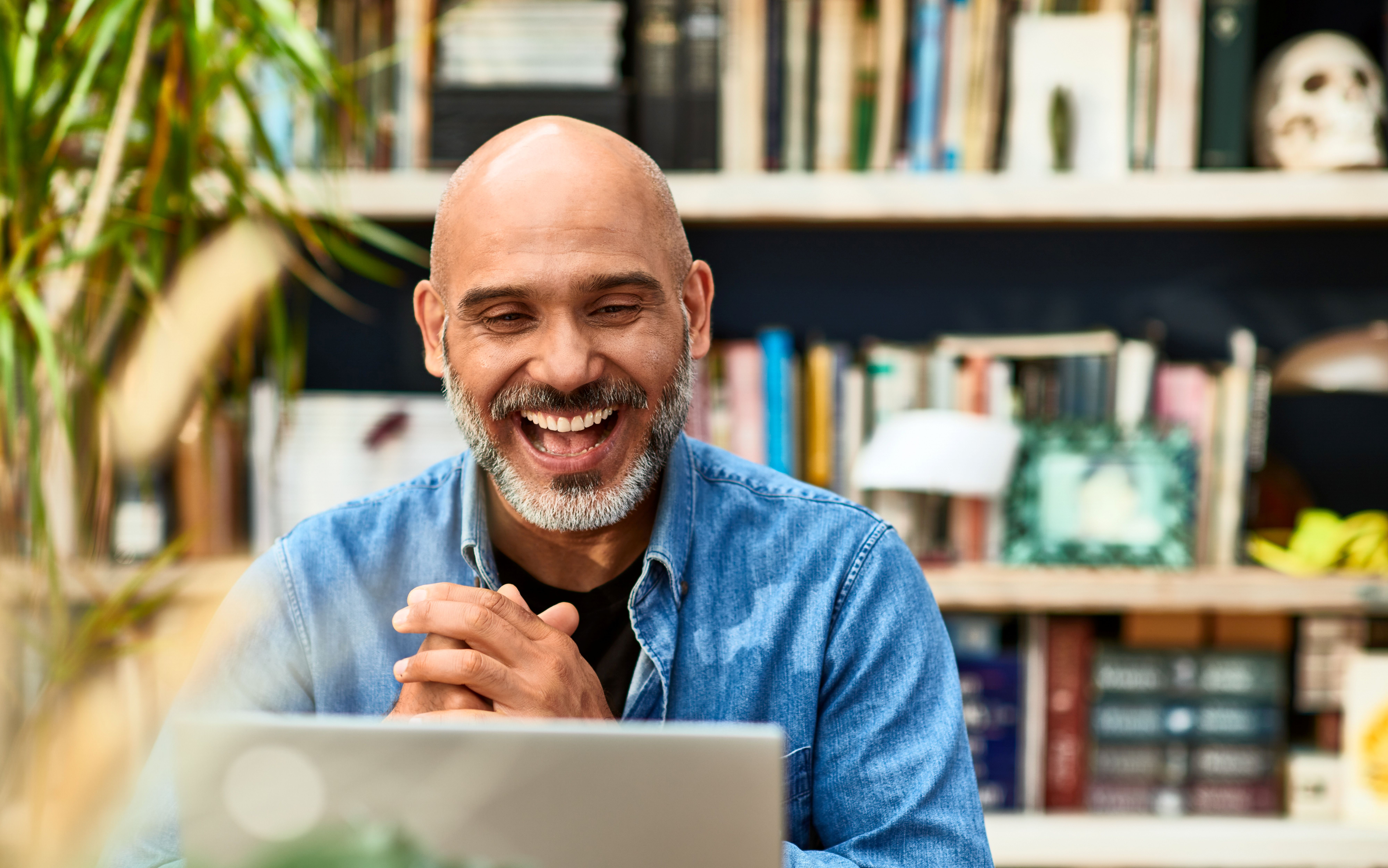 man smiling at laptop