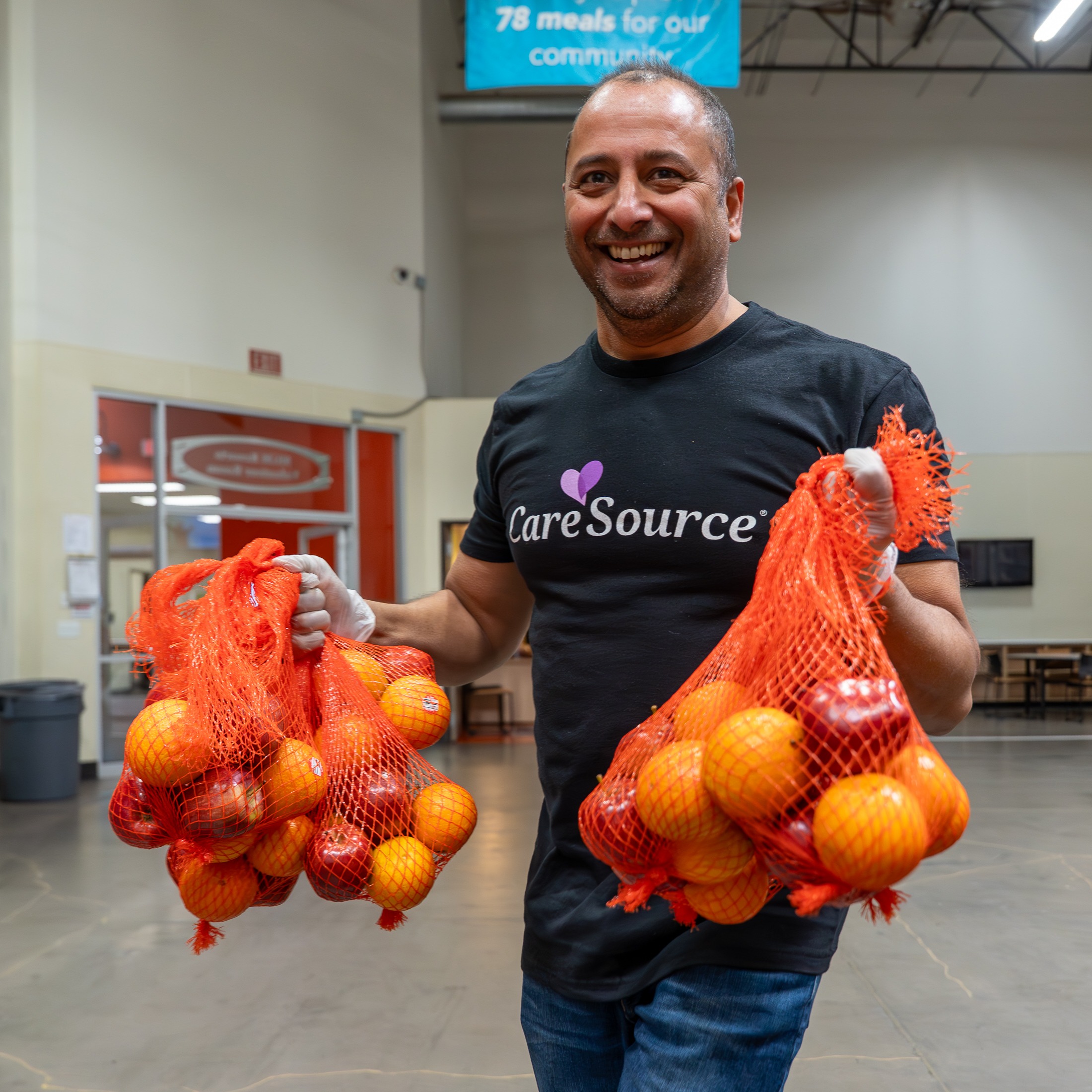 man holding oranges