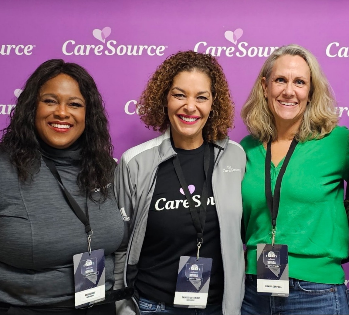 women in front of caresource banner