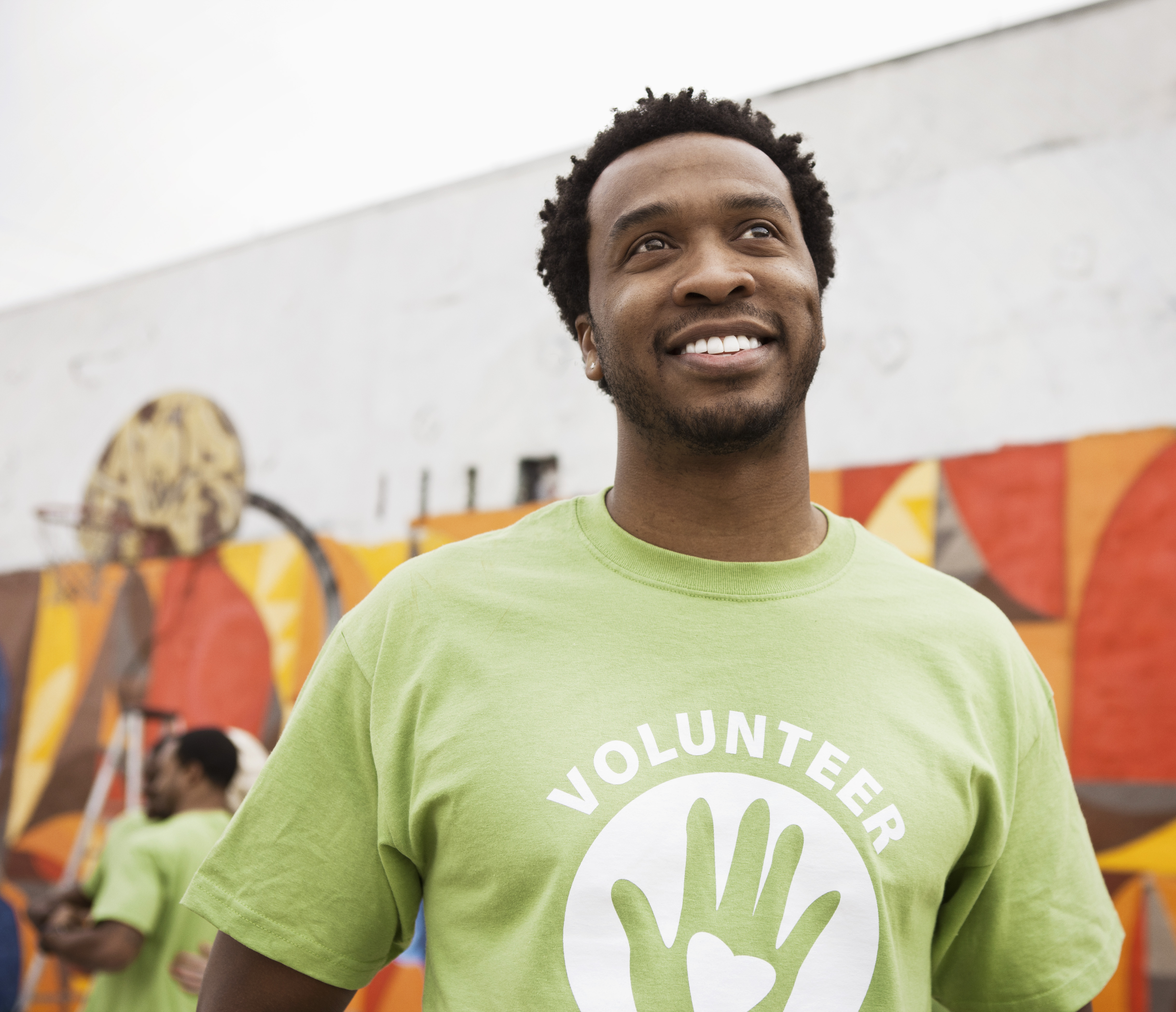 man in volunteer shirt smiling