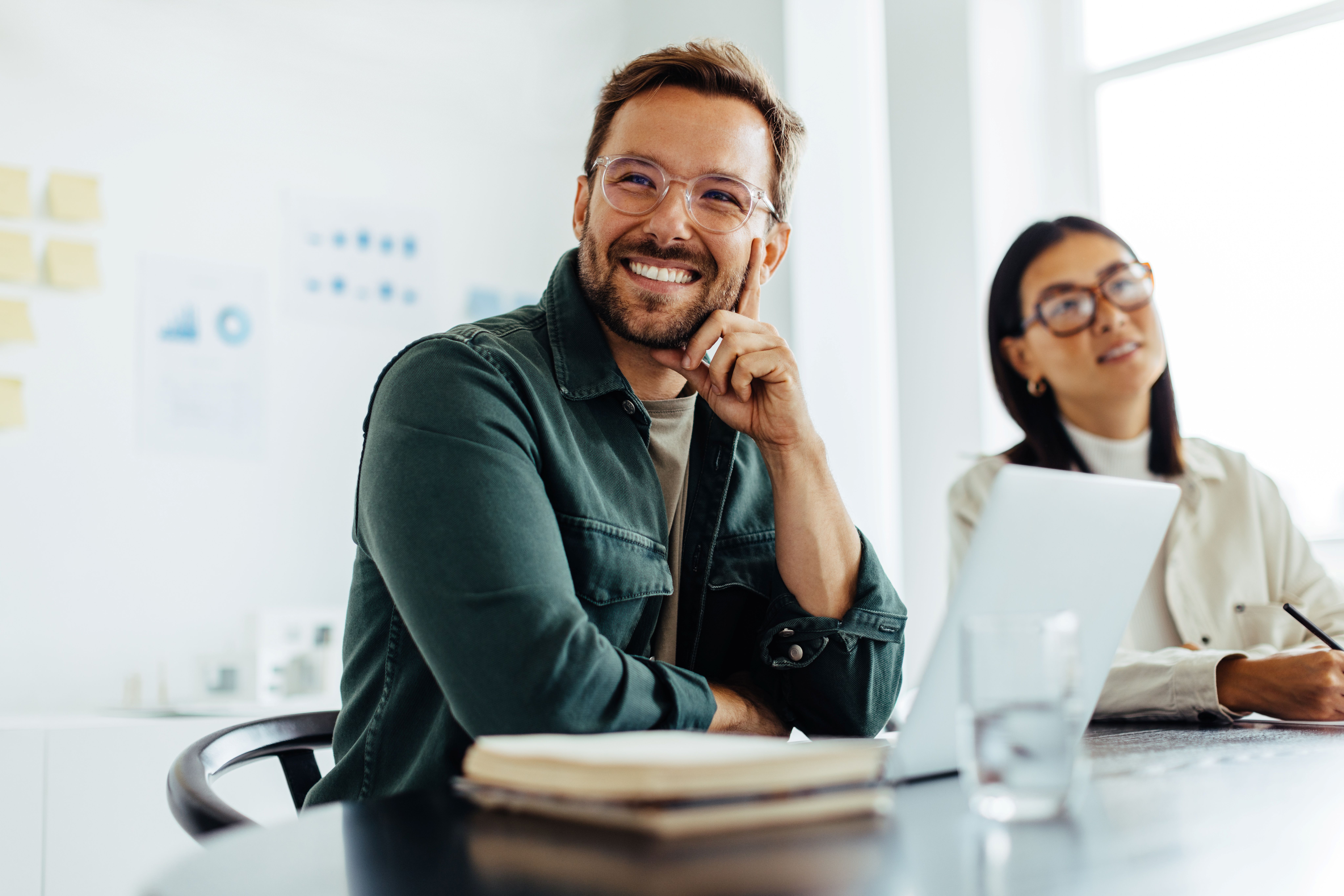 Man and woman at conference table smiling