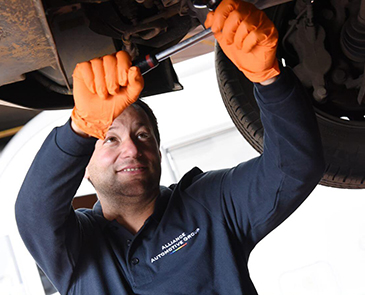 employee fixing an automobile