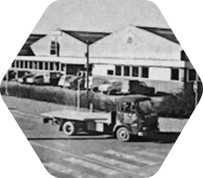 Black and white photo of a truck in front of a building