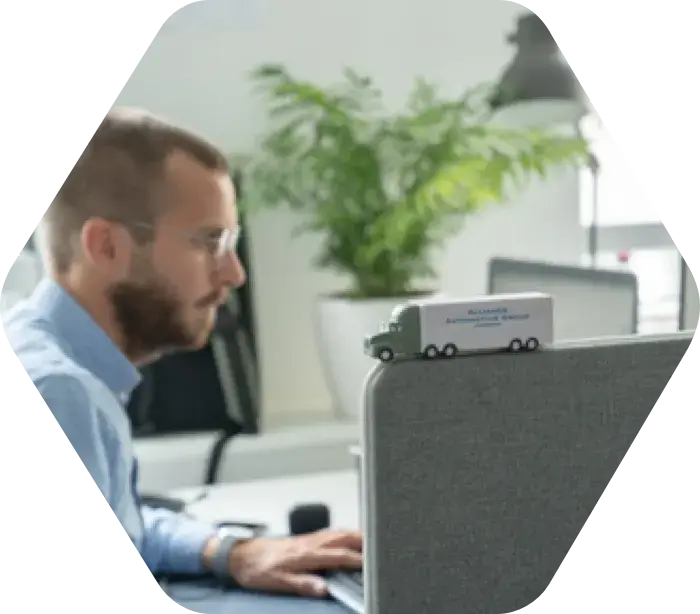 Alliance Automotive Group employee working at a desktop