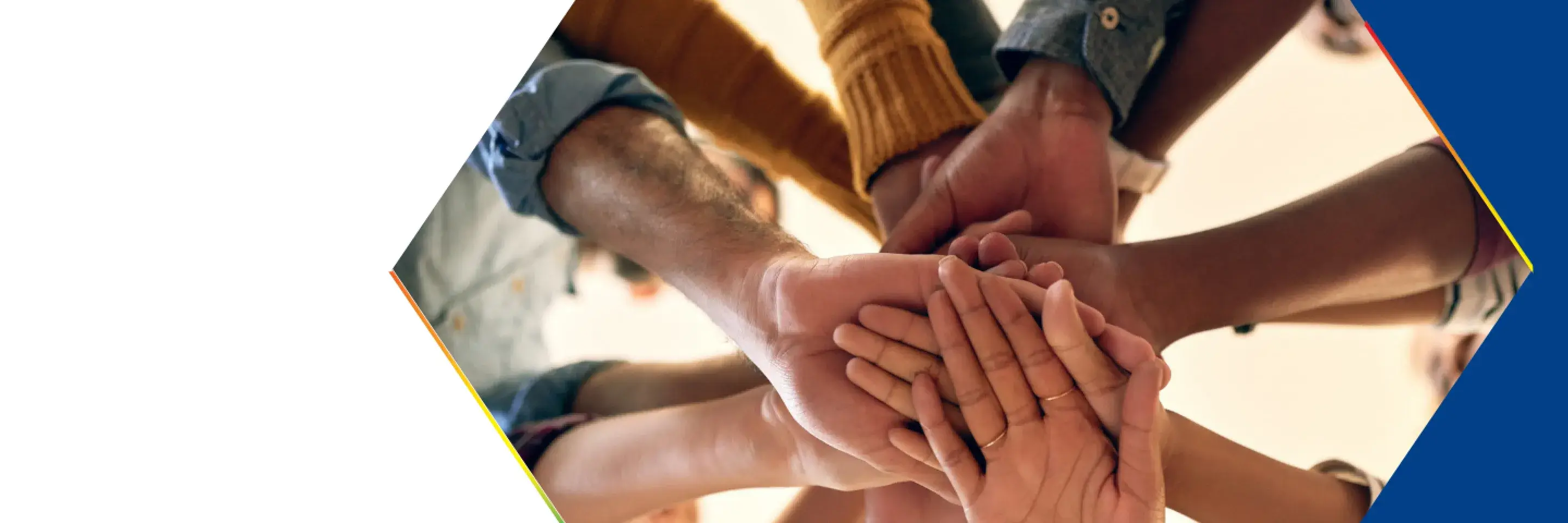Group of people putting there hands together in a huddle