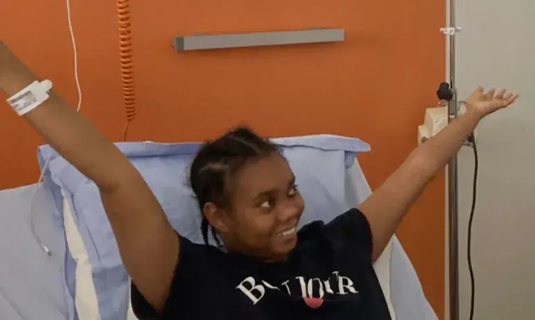 Girl in hospital bed smiling