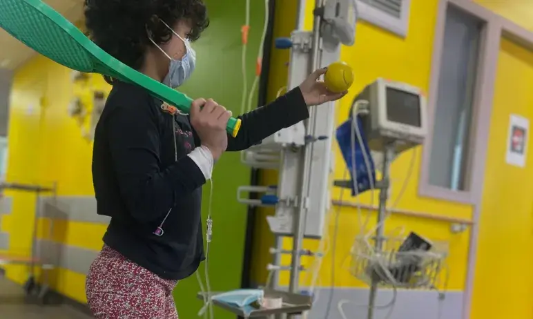 Child playing with a tennis racket
