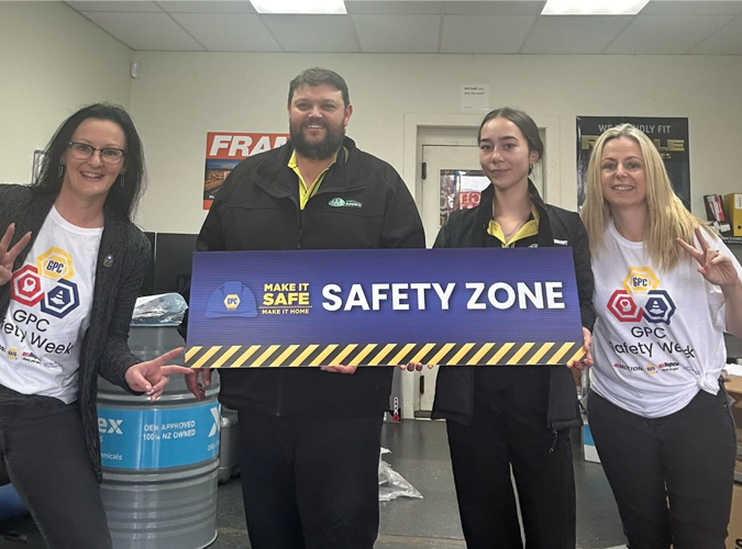 Three people with SAFETY ZONE banner