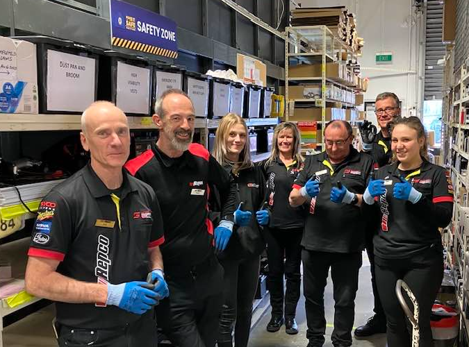 Group in warehouse aisle