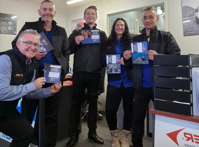 Team holding pledge cards