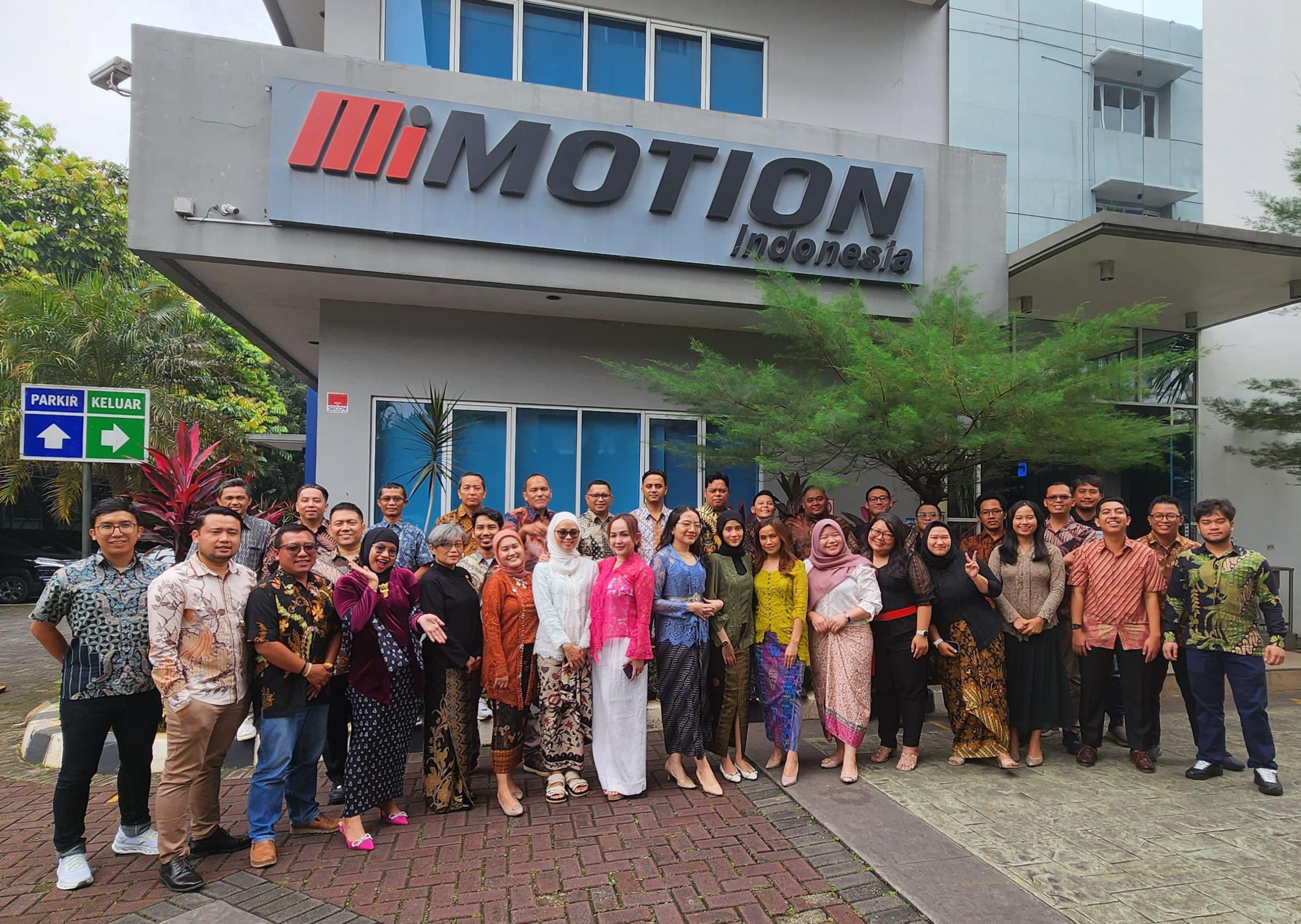 Team members at a company booth with branded banners.