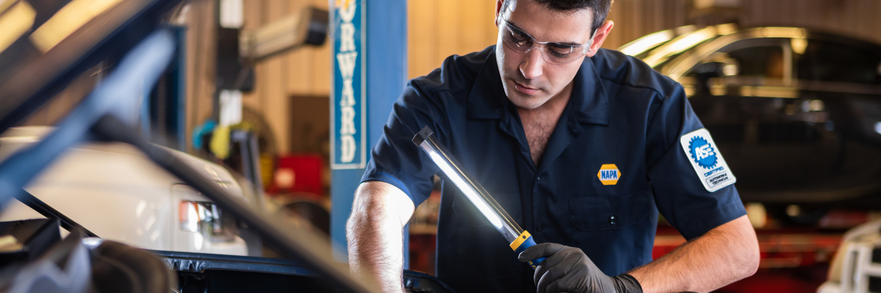 NAPA employee working on a car